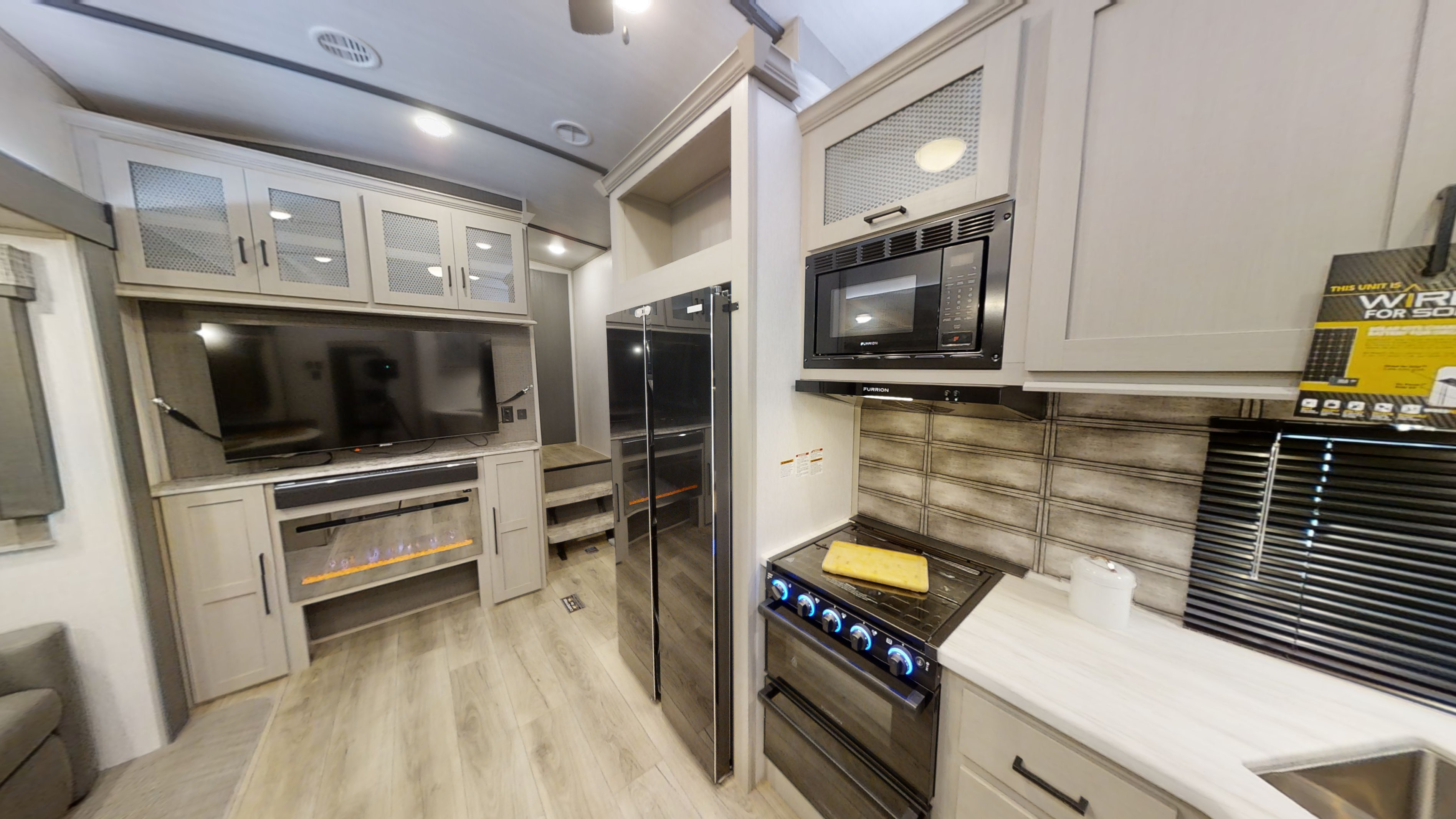 View of the kitchen and tv area.